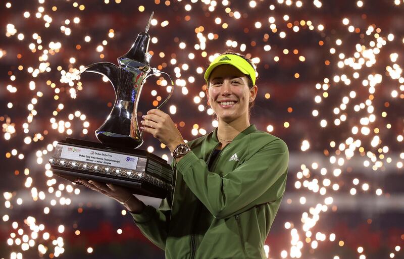 DUBAI, UNITED ARAB EMIRATES - MARCH 13: Garbine Muguruza of Spain celebrates with the trophy following victory during the Dubai Duty Free Tennis Women's Final match between Barbora Krejcikova and Garbine Muguruza on Day Seven of the Dubai Duty Free Tennis at Dubai Duty Free Tennis Stadium on March 13, 2021 in Dubai, United Arab Emirates. (Photo by Francois Nel/Getty Images)