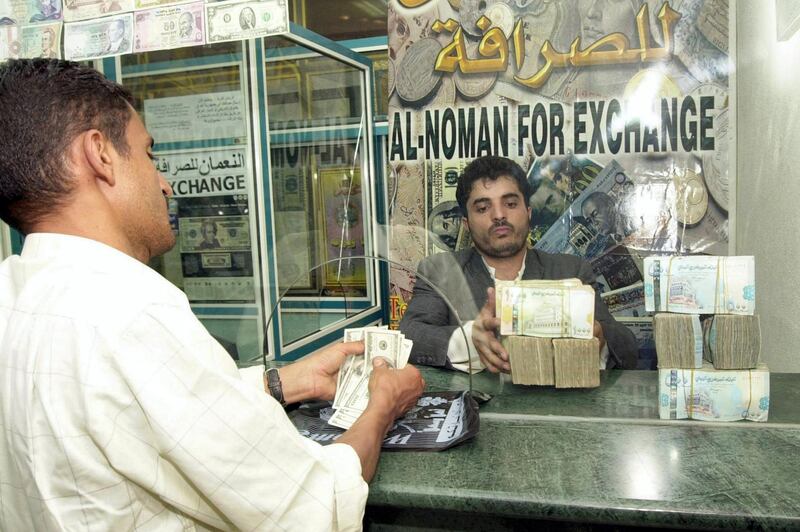 A Yemeni man exchanges money in Sanaa 26 June 2005. The Yemeni currency started last month gradually its collapsing in front of the foreign hard currency, but during the last few days it rabidly fell down, with the US Dollar price rising today up to 196 Riyals, which is the highest price for Dollar in the history of Yemeni Riyal. AFP PHOTO/KHALED FAZAA / AFP PHOTO / KHALED FAZAA