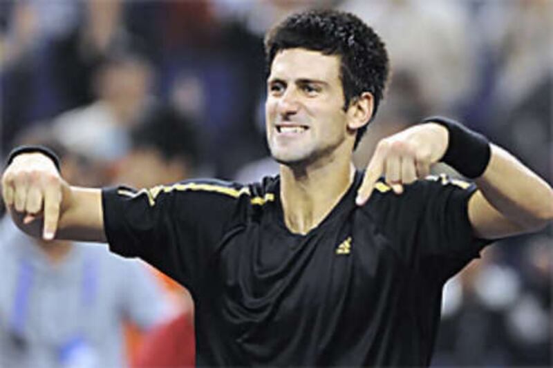 The Serbian Novak Djokovic celebrates his victory over the Russian Nikolay Davydenko in the men's singles final at the ATP Masters Cup.