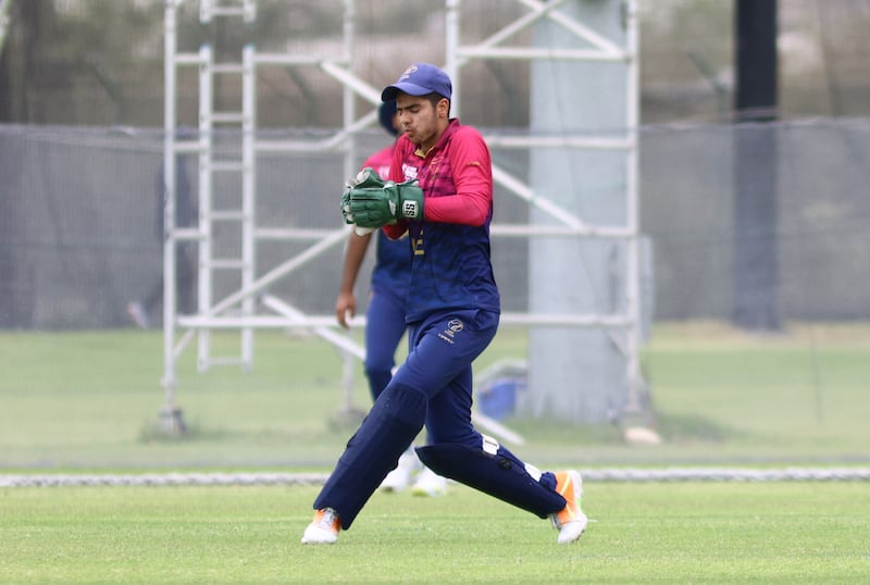 Wicketkeeper Tanish Suri of UAE holds on to a catch.