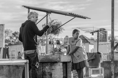 This image released by Netflix shows filmmaker Alfonso Cuaron, left, and actress Yalitza Aparicio on the set of "Roma." On Thursday, Dec. 6, 2018, Cuaron was nominated for a Golden Globe award for best director for the film. The 76th Golden Globe Awards will be held on Sunday, Jan. 6. (Carlos Somonte/Netflix via AP)