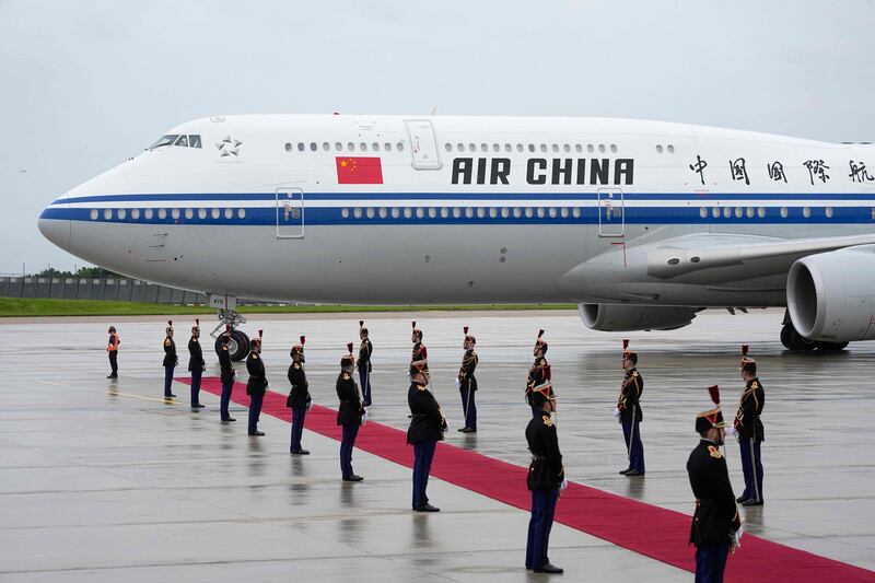 Members of France's Republican Guard form an honour guard for the arrival of Mr Xi and Ms Peng at Orly airport, south of Paris, on Sunday. AFP