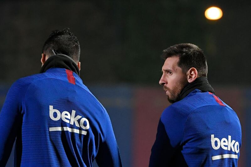Barcelona forward Lionel Messi speaks with Luis Suarez. AFP