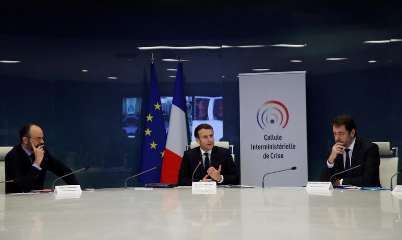 French President Emmanuel Macron, centre, and government ministers attend a meeting at the emergency crisis centre of the Interior Ministry in Paris on March 20, 2020 to discuss the coronavirus pandemic. EPA