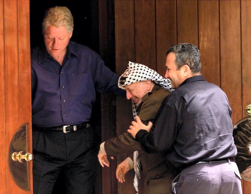 Israeli Prime Minister Ehud Barak (R) jokingly pushes Palestinian President Yasser Arafat (C) into the Laurel cabin on the grounds of Camp David as U.S. President Bill Clinton watches during peace talks, July 11. Arafat and Barak were insisting that the other proceed through the door first. Camp David is the venue where Egypt and Israel made peace in September 1978, and the Laurel cabin was the site of many of the meetings.

WM/RCS