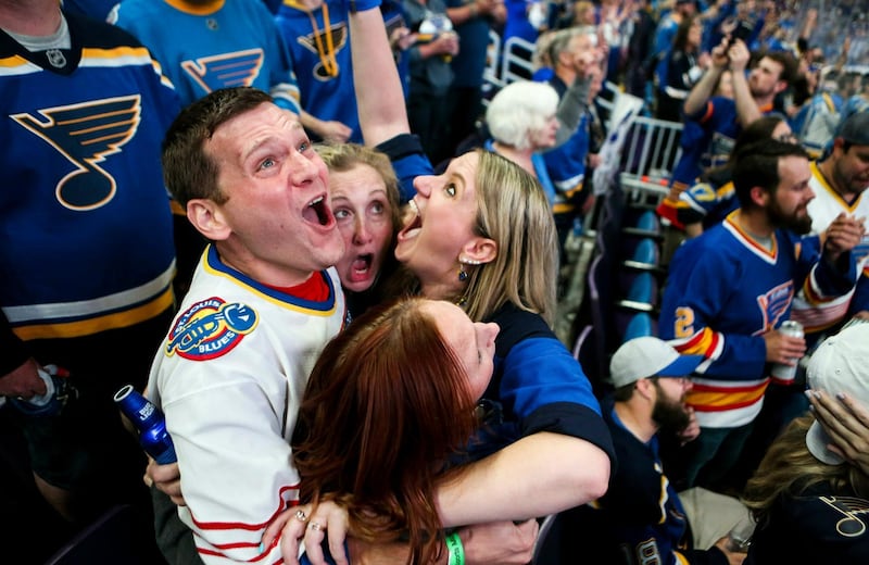 Bill Kess, left, and his friends react as the clock hits zero and the St. Louis Blues win the Stanley Cup over the Boston Bruins in Boston, during a watch party at Enterprise Center in St. Louis.  AP