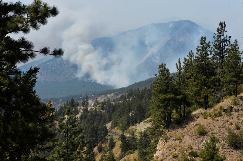 A wildfire burns outside of the town of Lytton, where a wildfire raged through and forced everyone to evacuate, in British Columbia, Canada, July 1, 2021.