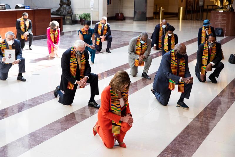US Speaker of the House Nancy Pelosi and Democratic politicians kneel while observing a moment of silence on Capitol Hill in Washington, DC.  EPA