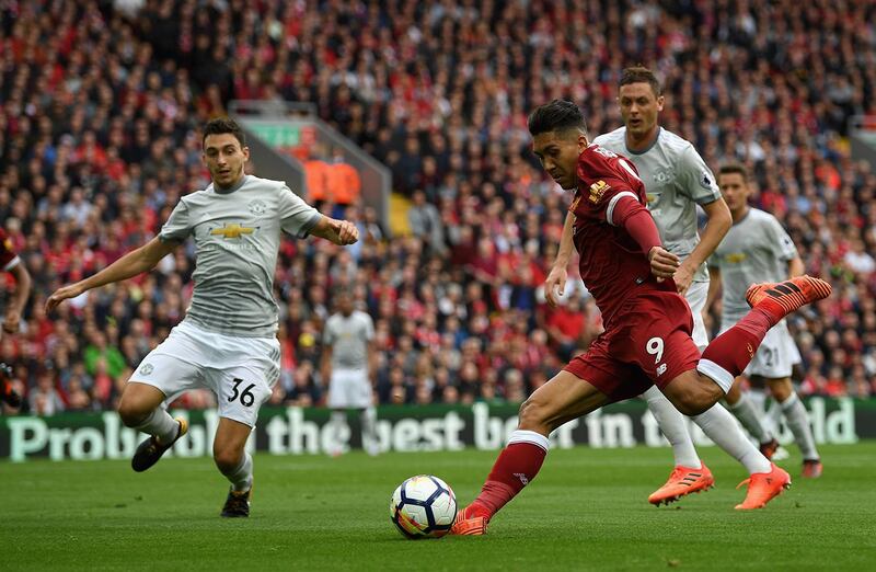 LIVERPOOL, ENGLAND - OCTOBER 14:  Roberto Firmino of Liverpool shoots during the Premier League match between Liverpool and Manchester United at Anfield on October 14, 2017 in Liverpool, England.  (Photo by Shaun Botterill/Getty Images)