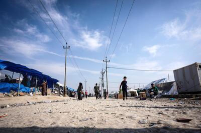 Residents of Bardarash camp in Iraqi Kurdistan, at capacity with 12,000 residents, walk along its main dirt track on November 1, 2019. Jack Moore / The National