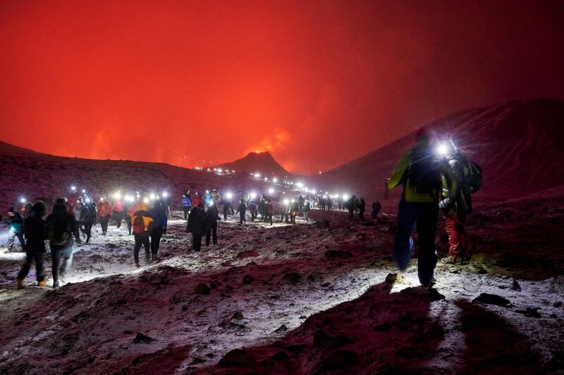 Sunday hikers in the Geldingadalur valley make their way to the site of a volcanic eruption on the Reykjanes Peninsula, Iceland. AFP