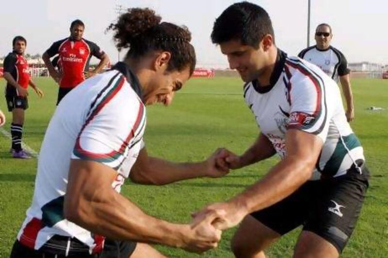 Emirati players work on strengthening drills during practice at the Sevens pitch.