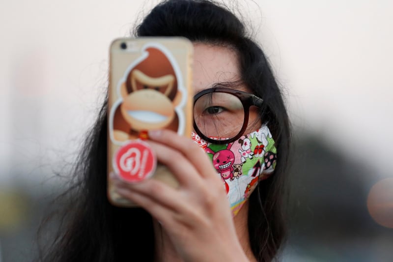 A fan uses her mobile phone during a screening for the movie "The Rental" at the Vineland Drive-In movie theater in City of Industry, California, USA. Reuters