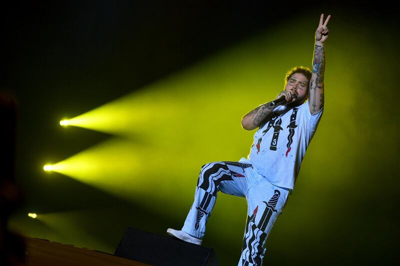 US singer, rapper, songwriter and producer Post Malone performs on stage at the "Sziget" Island Festival in the Hajogyar (Shipyard) Island of Budapest on August 11, 2019. - The 26-year-old festival, that offers hundreds concerts and other cultural events on an island in the middle of the Danube river in the heart of Budapest, runs until August 13, 2019. (Photo by ATTILA KISBENEDEK / AFP)