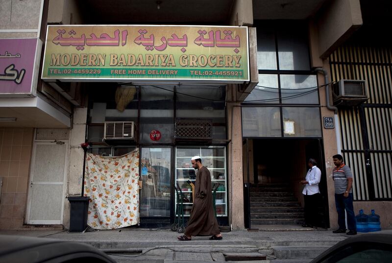 Abu Dhabi, United Arab Emirates, January 10, 2013: 
A man walks by the Modern Badariya Grocery, a recently closed convenience store on Thursday, Jan. 10, 2013, in the city block between Airport and Muroor, and Delma and Mohamed Bin Khalifa streets in Abu Dhabi. 
Silvia Razgova/The National

