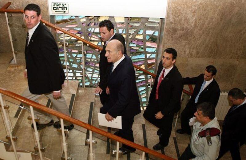 Ehud Olmert, centre, the Israeli prime minister, on his way to yesterday's cabinet meeting.