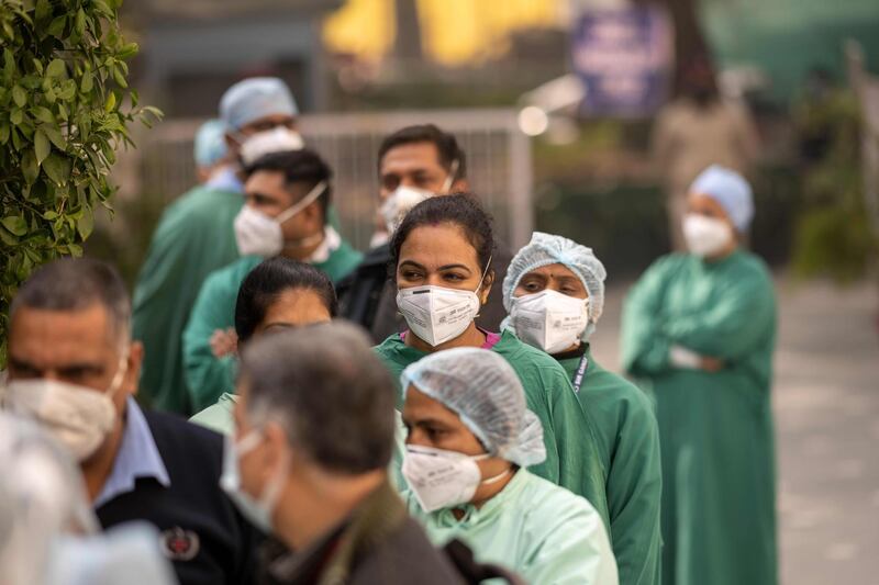 Medical workers wait to be inoculated against Covid-19 at a hospital in New Delhi. AFP