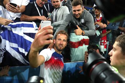 MOSCOW, RUSSIA - JULY 03:  Harry Kane of England celebrates victory by taking selfie photogrpahs with fans after the 2018 FIFA World Cup Russia Round of 16 match between Colombia and England at Spartak Stadium on July 3, 2018 in Moscow, Russia.  (Photo by Clive Rose/Getty Images)