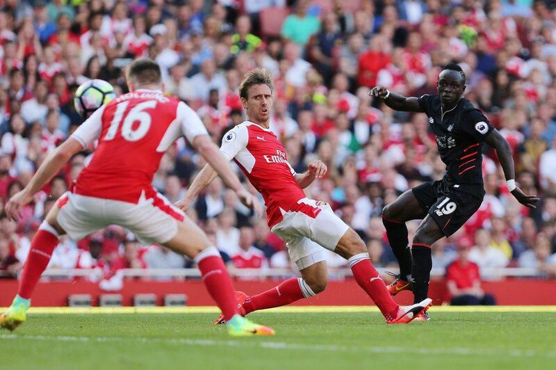 Liverpool’s Senegalese midfielder Sadio Mane (R) scores Liverpool’s fourth goal during the Premier League football match between Arsenal and Liverpool at the Emirates Stadium in London on August 14, 2016. Lee Mills / AFP