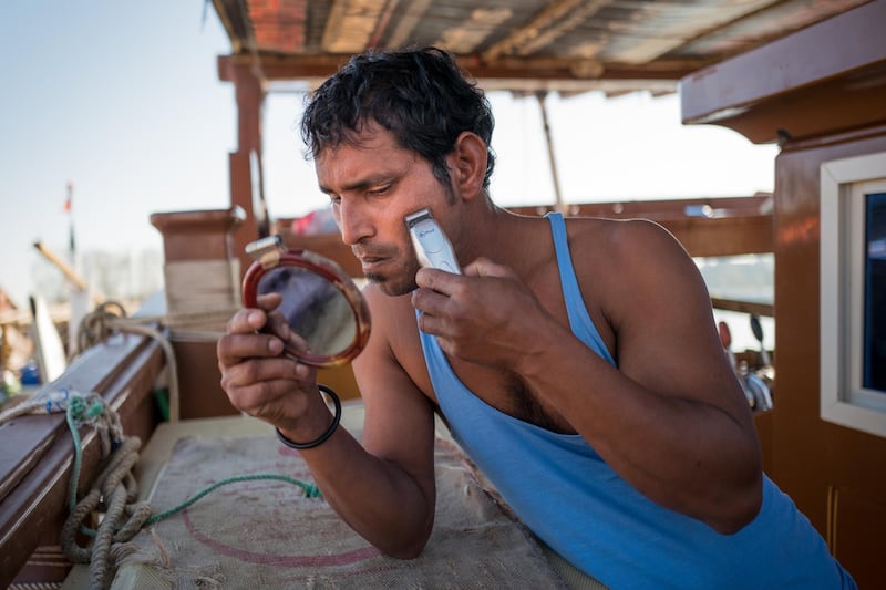 Mukesh Tandel, 30, trims his beard. Before he goes to sea, Tandel always takes the time to shave. Courtesy Sohail Karmani