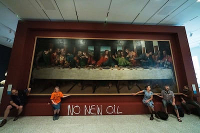 Five Just Stop Oil activists spray-paint the wall and glue themselves to the frame of the painting 'The Last Supper' at Royal Academy, London. Getty Images