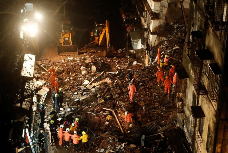 National Disaster Response Force and fire brigade personnel look for survivors trapped in the debris after part of a residential building collapsed in Mumbai, India on July 16, 2020, killing six people. Reuters