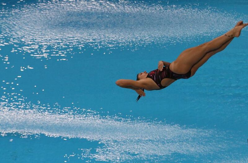 Pamela Ware of Canada dives at the Fina Diving World Series 2014 at the Hamdan Sports Complex. Karim Sahib / AFP  