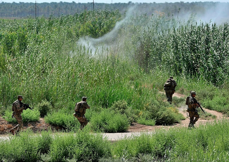 Security forces detonate an explosive device placed by the Islamic State militants during a search operation in Taramiyah, 50 kilometers (31 miles) north of Baghdad, Iraq, Tuesday, July 23, 2019. Security forces are sweeping villages and farmland north of Baghdad as part of an operation aimed at clearing remaining militants belonging to the Islamic State group from around the country's capital. (AP Photo/Hadi Mizban)