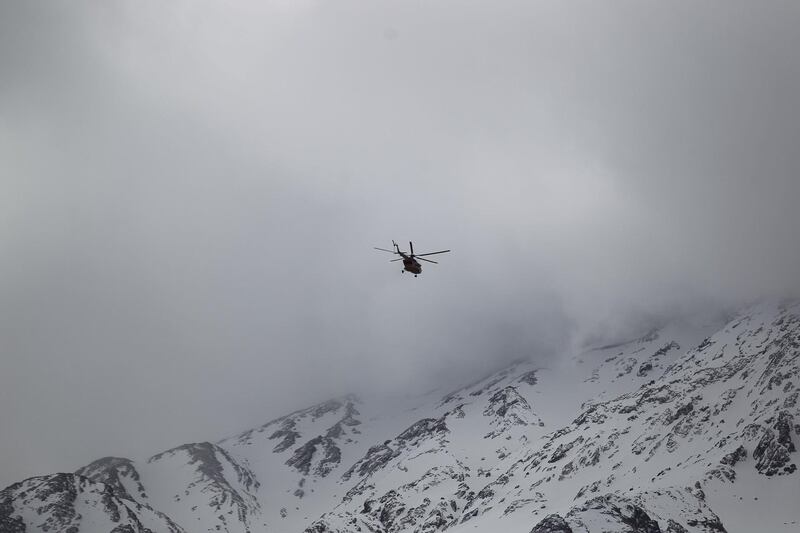 Emergency and rescue helicopter searches for the plane that crashed in a mountainous area of central Iran. Tasnim News Agency / Reuters