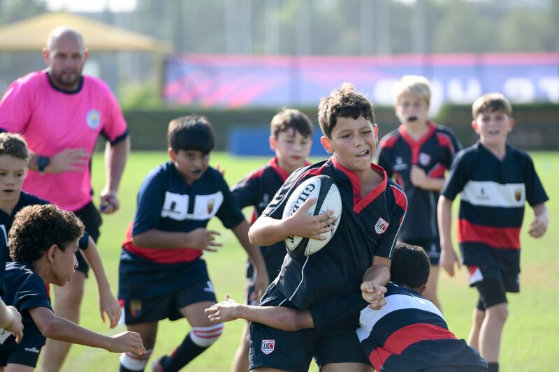 A Dubai College player runs with the ball. Khushnum Bhandari / The National