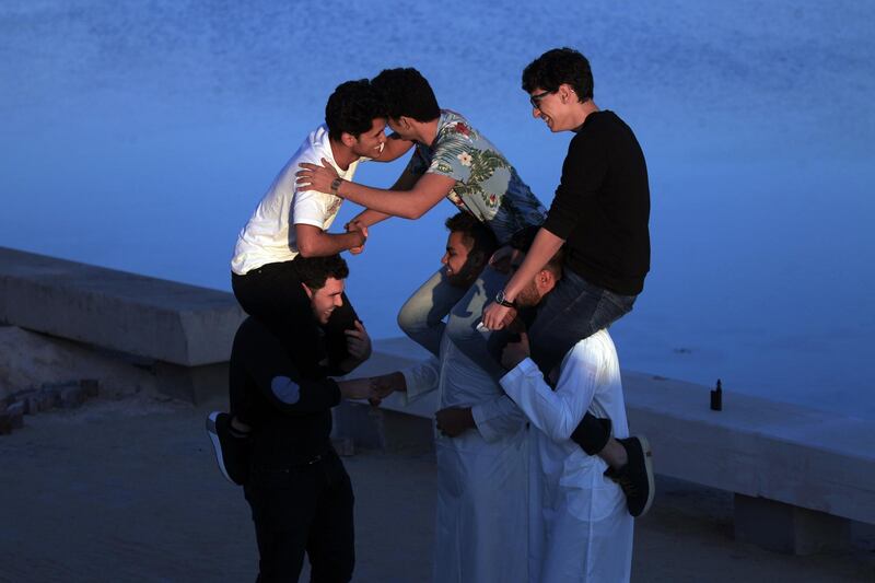 Libyan men exchange Eid Al Fitr greetings at the Libyan port of Benghazi. AFP