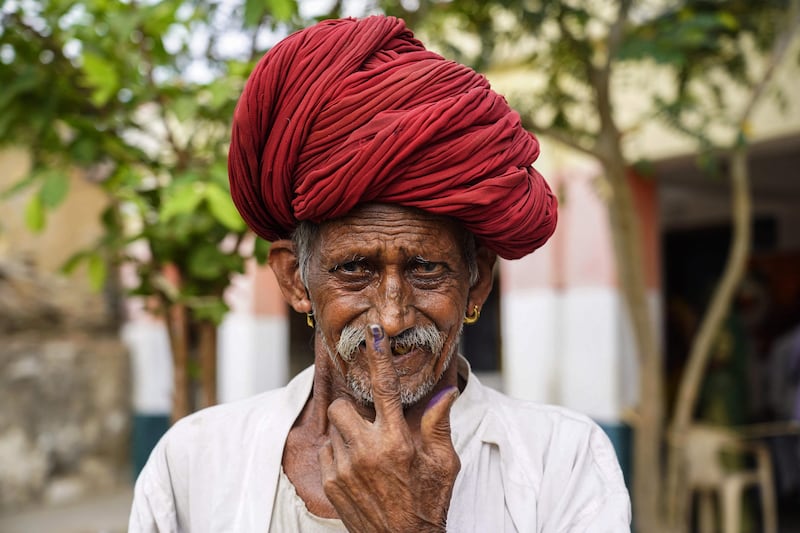 A man shows his finger, marked with indelible ink that indicates a person has voted, in Masuda, India. AFP