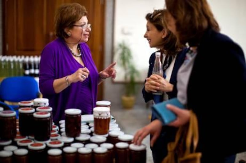 Left, Nahed Jabr Nsouli (cq), talks to ladies during a charity sale at the Ashghalona Charity Exhibition on Tuesday, Feb. 22, 2011, at the General Women's Union Headquarters in Abu Dhabi. The Beirut based organization helps widowed women by training them in further in cooking or sowing so the women can sell their handiwork and thus become self-sufficient. Oftentimes, after a woman becomes a widow, her children become in danger of becoming orphans as the family looses its bread-winer in the man. The organization was started 25 years ago in Lebanon and now, that it has gained some traction there, it's expanding abroad to attract financing from outside.  All of the proceeds from the sale go directly back to the women, their training, and health insurance for themselves and their children. 
(Silvia R‡zgov‡ / The National)