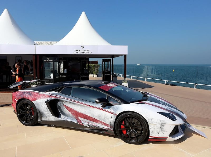 A 2016 Lamborghini Aventador in a head-turning chipped red, white, and black livery.