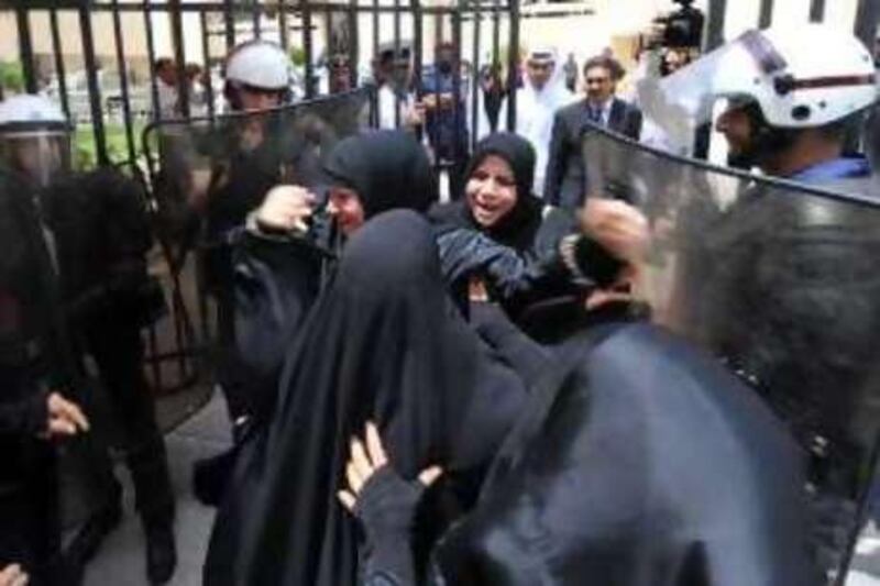 A female relative of one of the sentenced detainees taunts anti-riot police as she leaves the courthouse.

Mazen Mahdi/The National