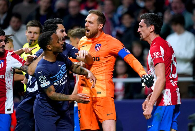 Atletico Madrid goalkeeper Jan Oblak steps inbetween Stefan Savic and City's Raheem Sterling as tempers flare. PA