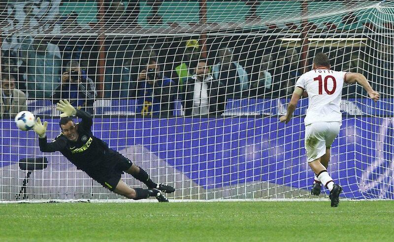 Francesco Totti (right) scores the first of his two goals on a 40th-minute penalty. Spada / AP