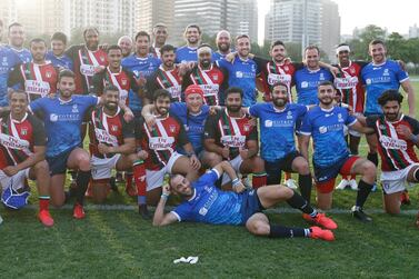 epa09083991 Player of Israel (blue) and players of UAE pose for photographs after the friendly Rugby match between the UAE and Israel, in Dubai, United Arab Emirates, 19 March 2021. The Israeli team came to the country for a joint training camp with the UAE national squad and their first ever match in rugby. EPA/ALI HAIDER