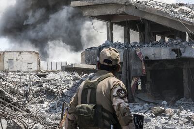 An Iraqi soldier looks at the site of an air strike that struck an ISIS sniper position in Al Shifa, west Mosul. Photo: Getty Images