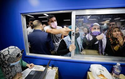 People wait to register at a Covid-19 vaccination centre in the Sadat underground metro station in Cairo, Egypt. Reuters