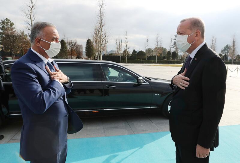 Turkish President Recep Tayyip Erdogan and Iraqi Prime Minister Mustafa Al Kadhimi adhere to social distancing during a welcoming ceremony in Ankara. AP