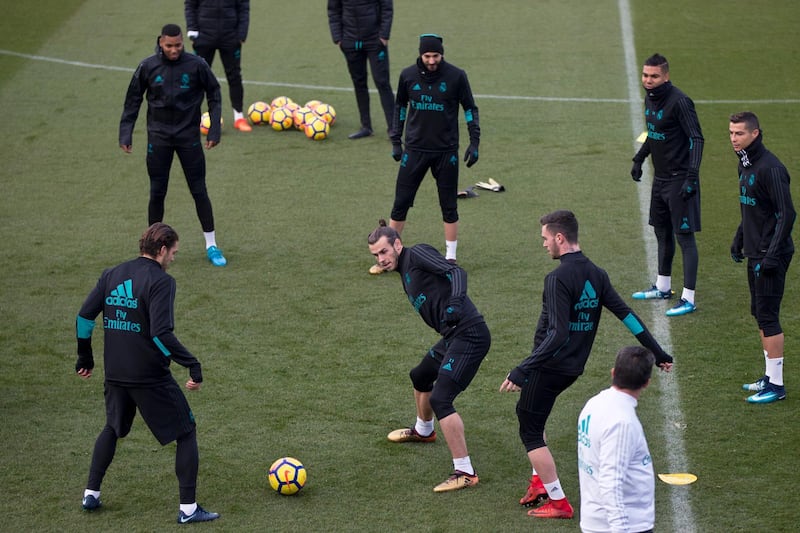 Real Madrid's Gareth Bale, centre, tries to get the ball from his team mates during a training session in Madrid, Spain, Friday, Dec. 8, 2017. Real Madrid will play Sevilla Saturday in league soccer match. (AP Photo/Paul White)