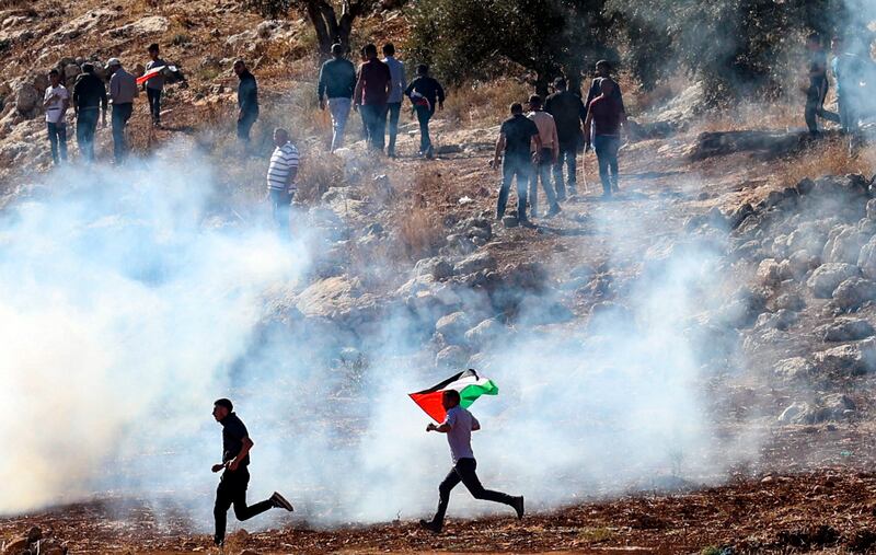 Israeli security forces used tear gas, rubber bullets and live rounds to disperse protesters in the protests. A 13-year-old Palestinian was shot and killed. Photo: AFP