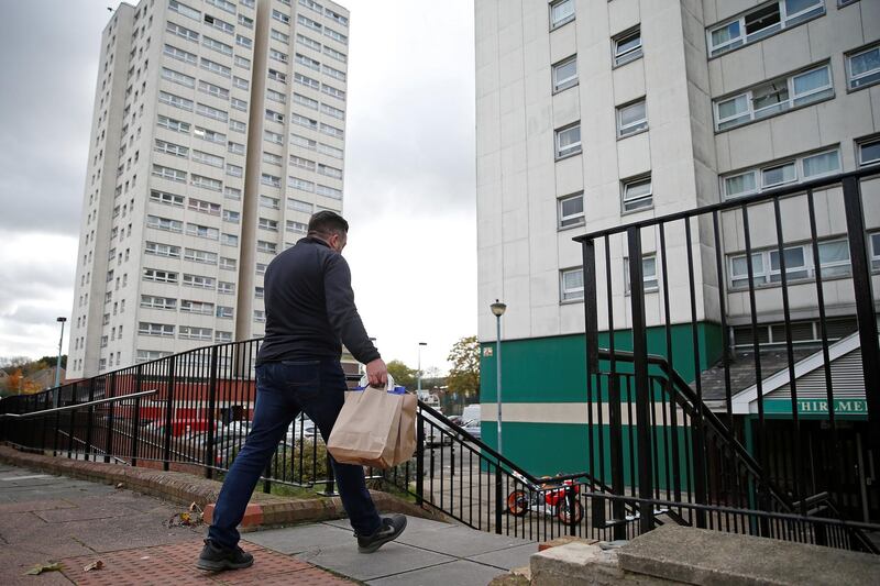 Dom Palacio, Head of Community at Richmond Rugby, delivers meals to local school children living in a block of flats on the Ivybridge estate in Twickenham, south west London. AFP