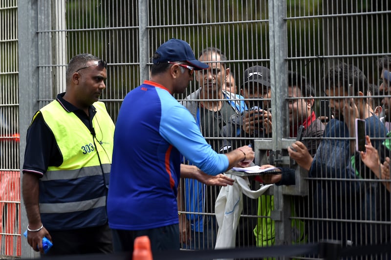 Indian team coach Rahul Dravid signs autographs for fans after at Edgbaston. AP