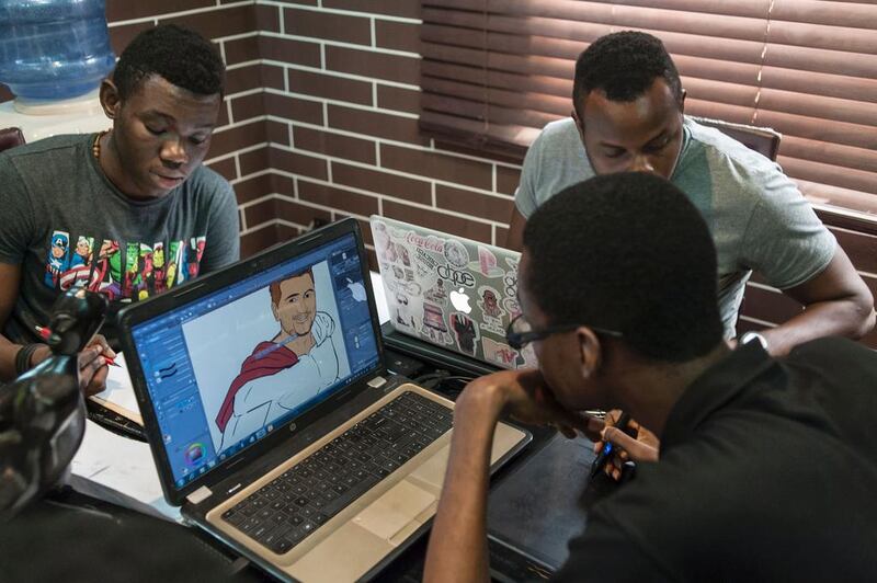 Illustrators work on various projects at the Comic Republic office in Lagos. Stefan Heunis / AFP