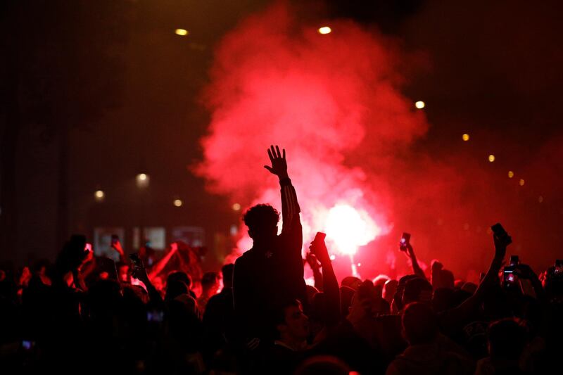 PSG supporters gather on the Champs-Elysees. AP