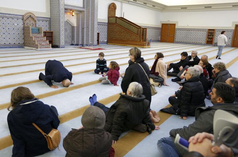 People listen to the explanations of guide Mohamed Latahi as they visit the Strasbourg Grand Mosque on January 9, 2015, during a two-day open-house event for mosques in France. Vincent Kessler/Reuters