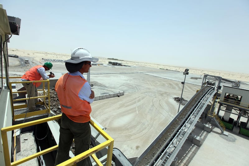 May 10, 2010/ Abu Dhabi /  Andy Baird, front,  a production manager and Josh Maree an engineer for a new recycling plant located at the Al Dhafra Landfill watch as the plant recycles construction and demolition waste.  (Sammy Dallal / The National)


