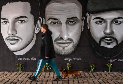 A man passes in front of a mural with portraits of victims of the 2020 Hanau shootings under a bridge in Frankfurt am Main, western Germany, on February 18, 2021, one day before commemorations to honour the victims.   The Hanau shootings occurred on February 19, 2020, when a gunman later identified as Tobias R. killed nine people by opening fire in two bars in the German city of Hanau near Frankfurt/Main. The 43-year-old man was later found dead alongside the corpse of his mother in his home, leaving behind a 24-page xenophobic "manifesto". 
 - RESTRICTED TO EDITORIAL USE - MANDATORY MENTION OF THE ARTIST UPON PUBLICATION - TO ILLUSTRATE THE EVENT AS SPECIFIED IN THE CAPTION
 / AFP / Armando BABANI / RESTRICTED TO EDITORIAL USE - MANDATORY MENTION OF THE ARTIST UPON PUBLICATION - TO ILLUSTRATE THE EVENT AS SPECIFIED IN THE CAPTION
